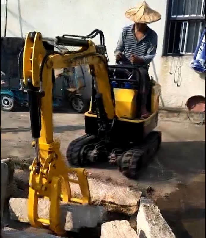 Mini excavator used to move stone